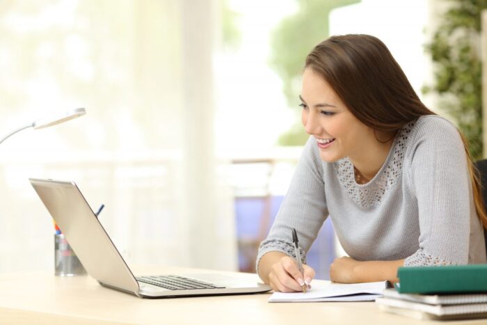 woman works as an online tutor on a laptop